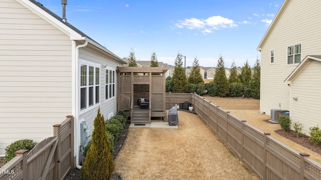 view of patio featuring fence, central AC, and a wooden deck