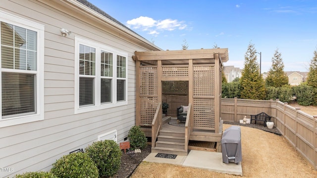 wooden terrace with a pergola and fence