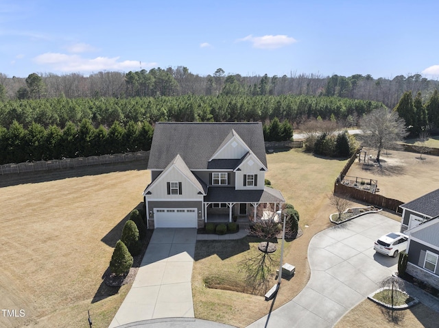 birds eye view of property with a wooded view