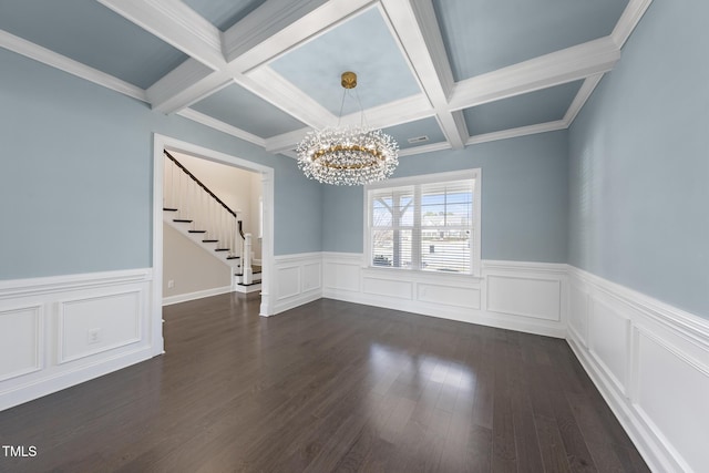 unfurnished dining area featuring stairs, beamed ceiling, a notable chandelier, and dark wood-style flooring