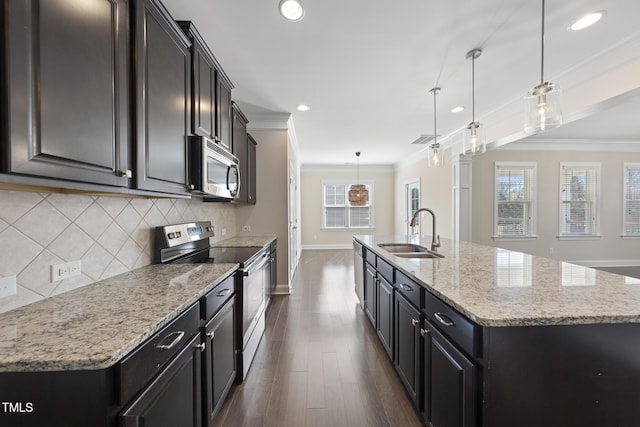 kitchen with a large island, ornamental molding, a sink, appliances with stainless steel finishes, and decorative backsplash