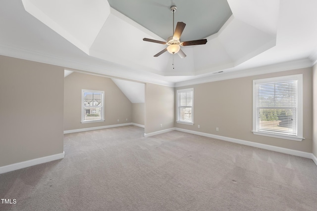 additional living space featuring baseboards, light colored carpet, and ceiling fan