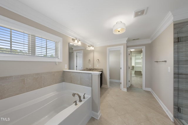 bathroom with visible vents, a garden tub, ornamental molding, baseboards, and a spacious closet