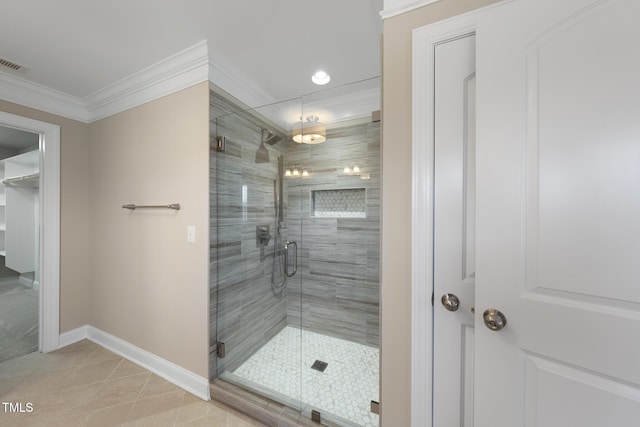 full bathroom with visible vents, baseboards, a stall shower, ornamental molding, and tile patterned floors