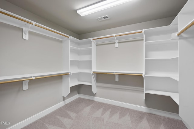 walk in closet featuring visible vents and carpet flooring