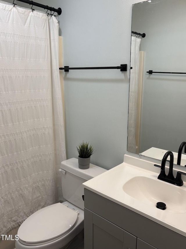 bathroom with toilet and vanity