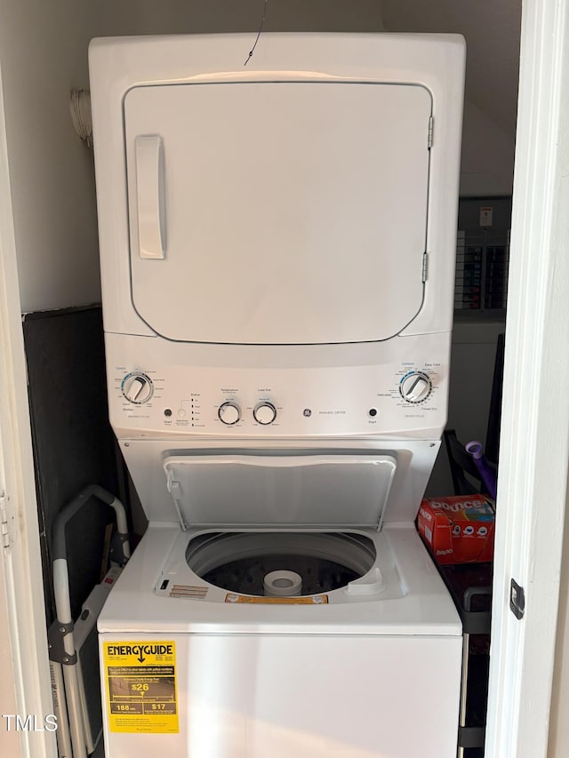 clothes washing area featuring stacked washer and dryer