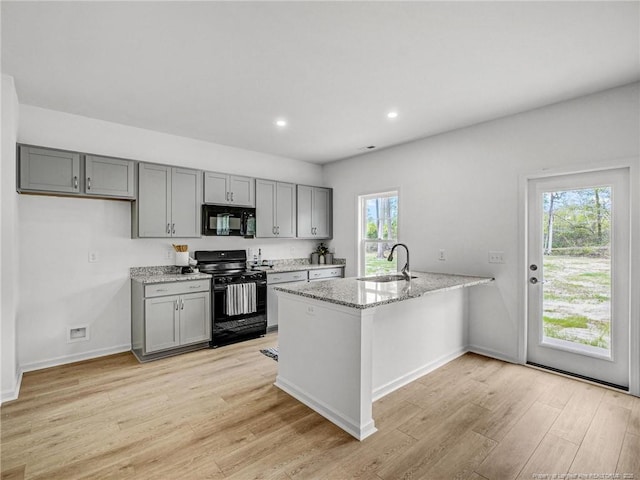 330 Penfield Way, Raeford, NC 28376 - kitchen featuring black appliances, gray cabinets, light wood finished floors, a peninsula, and light stone counters