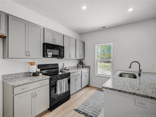 330 Penfield Way, Raeford, NC 28376 - kitchen with black appliances, gray cabinets, light stone countertops, light wood-type flooring, and recessed lighting