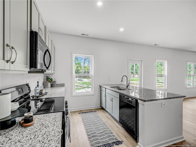 330 Penfield Way, Raeford, NC 28376 - kitchen featuring black appliances, healthy amount of natural light, dark stone countertops, and recessed lighting