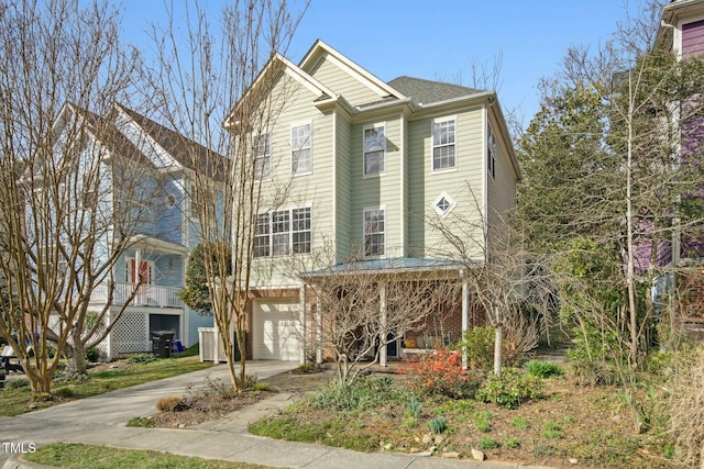 view of front facade with concrete driveway and a garage