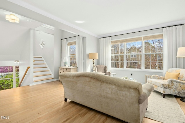 living room featuring light wood-style flooring and stairs