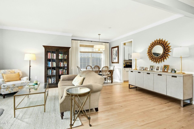 living area with light wood-type flooring and crown molding