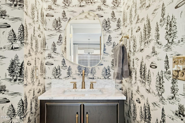 bathroom featuring vanity and wallpapered walls