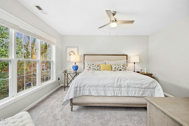 carpeted bedroom with visible vents, ceiling fan, and baseboards