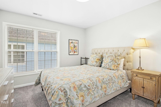 carpeted bedroom featuring visible vents and baseboards