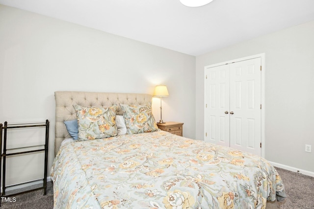 carpeted bedroom featuring a closet and baseboards