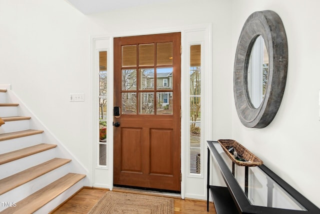 entryway with stairway and light wood-style floors