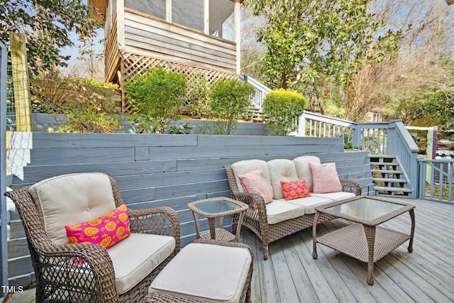 wooden deck with an outdoor living space