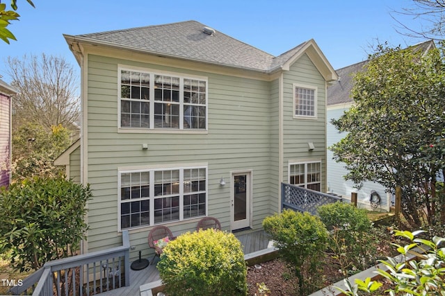 view of front of home featuring a wooden deck and a shingled roof