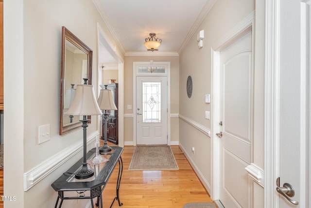 entrance foyer featuring light wood-style flooring, baseboards, and ornamental molding