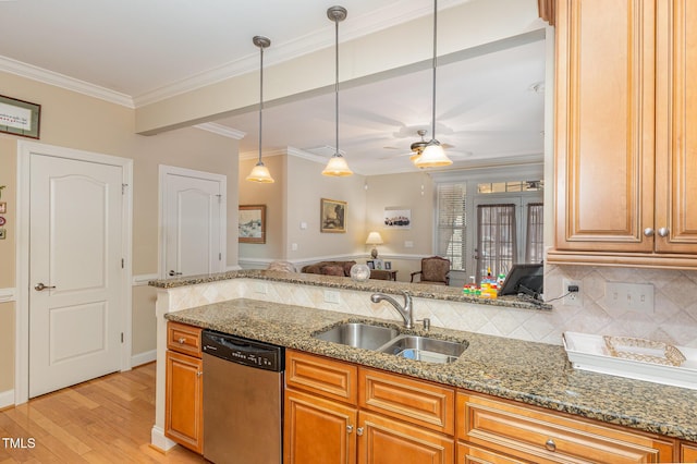 kitchen with light stone countertops, a sink, stainless steel dishwasher, tasteful backsplash, and light wood-type flooring