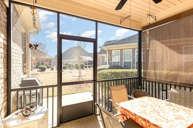 sunroom / solarium featuring ceiling fan