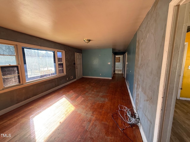 empty room with wood finished floors and baseboards