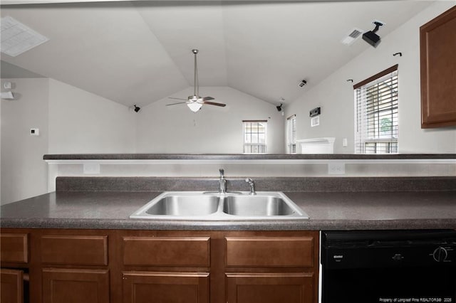 kitchen with visible vents, a sink, vaulted ceiling, black dishwasher, and dark countertops