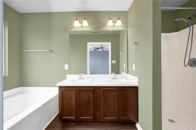 bathroom featuring a sink, a shower, a bath, and double vanity