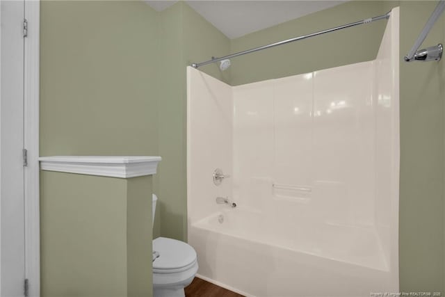 full bathroom with toilet, bathtub / shower combination, and wood finished floors