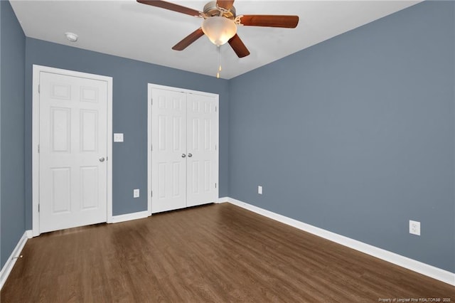 unfurnished bedroom featuring a closet, ceiling fan, baseboards, and wood finished floors