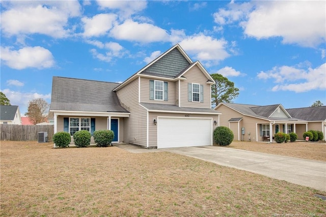 view of front of property featuring a garage, concrete driveway, a front yard, and fence