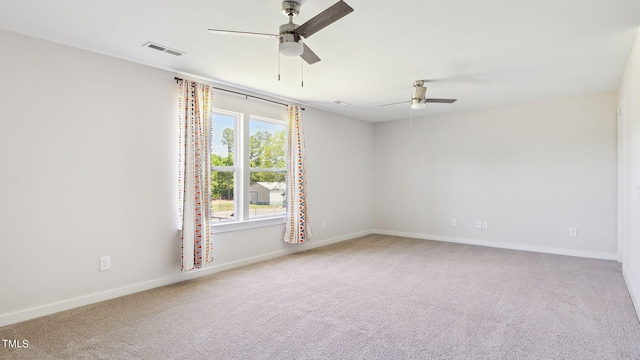 empty room featuring visible vents, ceiling fan, baseboards, and carpet floors