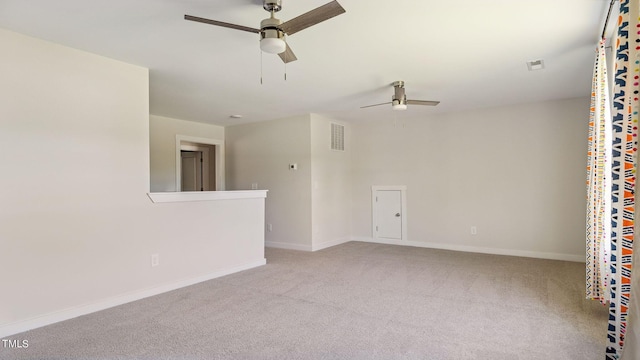 carpeted empty room featuring visible vents, baseboards, and a ceiling fan