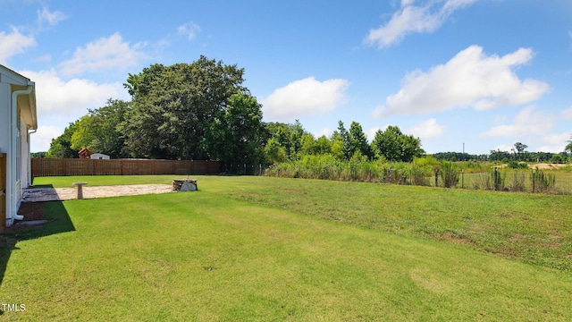 view of yard featuring a patio and fence