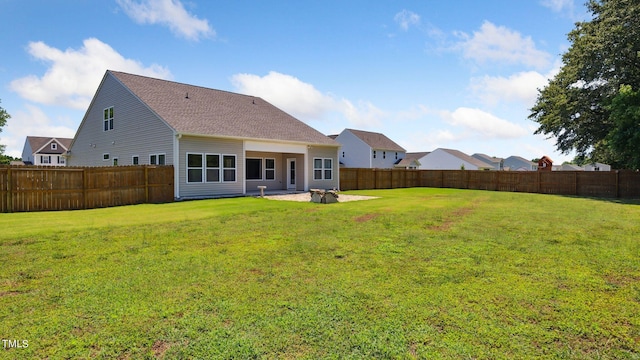 back of property featuring a fenced backyard, a patio, and a yard