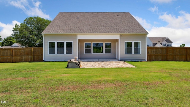 back of house featuring a yard, roof with shingles, and fence private yard