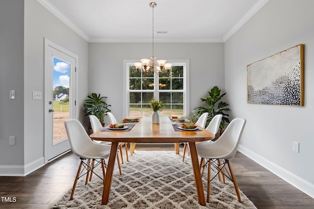 dining space with a chandelier, baseboards, dark wood-style flooring, and crown molding