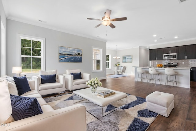 living area featuring baseboards, visible vents, dark wood finished floors, recessed lighting, and crown molding