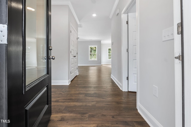 corridor featuring crown molding, recessed lighting, baseboards, and dark wood-style flooring