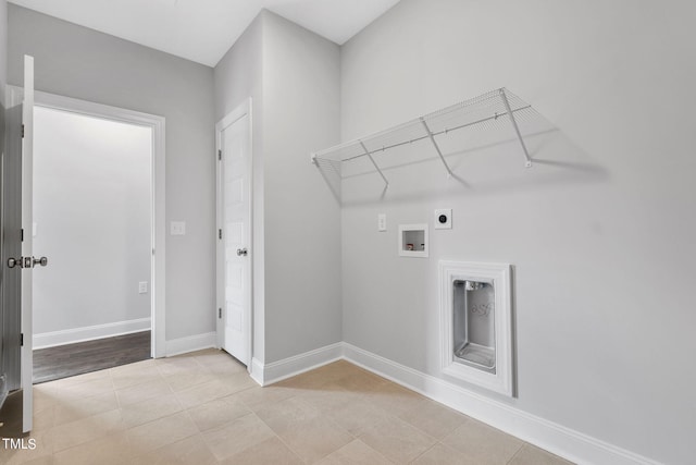 clothes washing area featuring electric dryer hookup, light tile patterned floors, baseboards, hookup for a washing machine, and laundry area