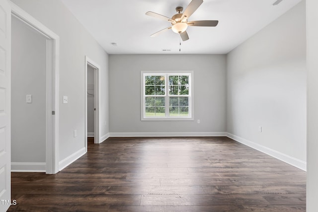 unfurnished room with dark wood finished floors, ceiling fan, and baseboards