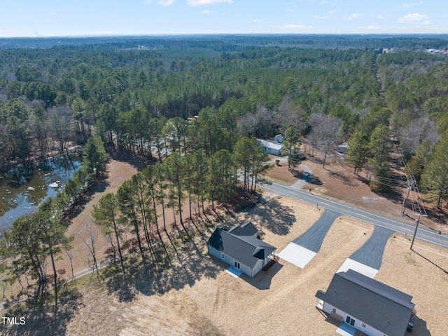 birds eye view of property featuring a wooded view