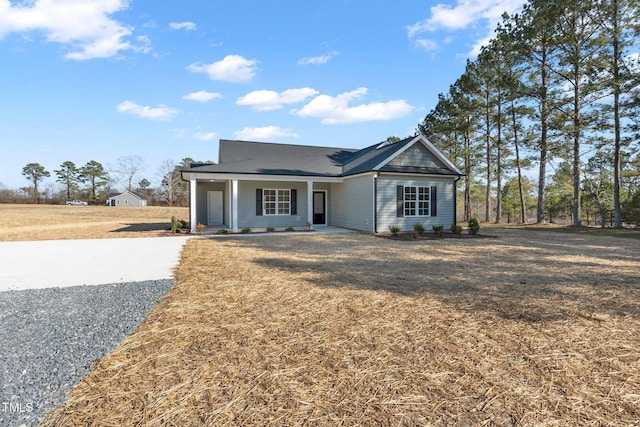 view of front facade with a front yard and covered porch