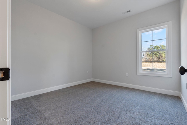 carpeted spare room with baseboards and visible vents