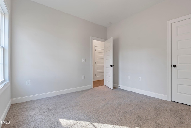 unfurnished bedroom featuring baseboards and carpet flooring