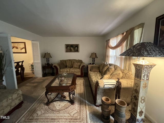 living room with baseboards and carpet