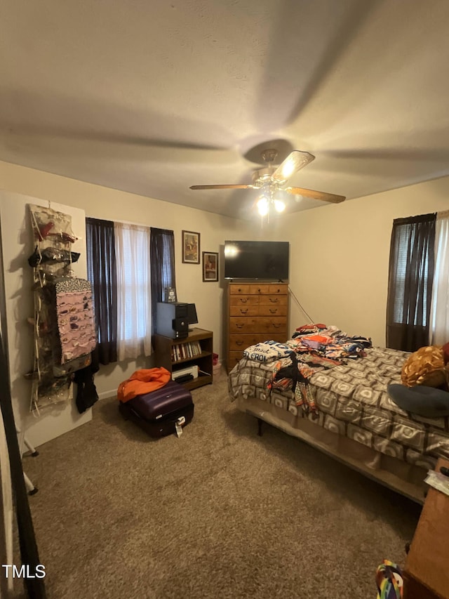 bedroom featuring a ceiling fan and carpet