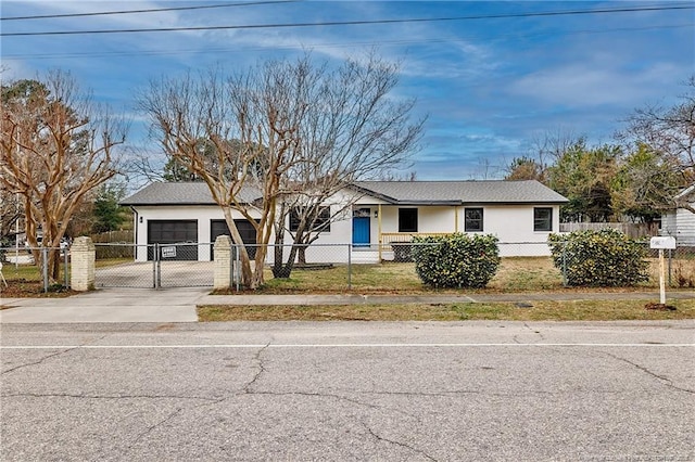 ranch-style house featuring a fenced front yard, concrete driveway, stucco siding, an attached garage, and a gate